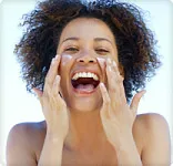 <br> Happy Woman Applying Face Cream