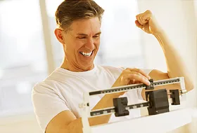 Excited Man Clenching Fist While Using Weight 