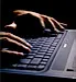 mans hands on laptop keyboard