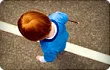 little boy walking in road