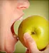 person biting into an apple