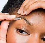 woman plucking eyebrows