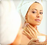 woman using moisturizer