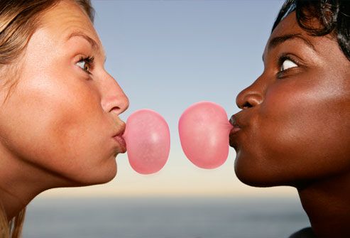 Two women blowing bubble gum