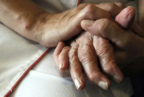 Nurse Holding Alzheimer Patient Hand