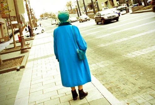 Elderly Woman Standing on Sidewalk