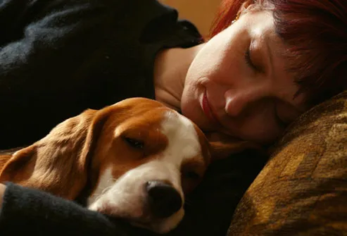 getty_rf_photo_of_woman_sleeping_with_dog.jpg