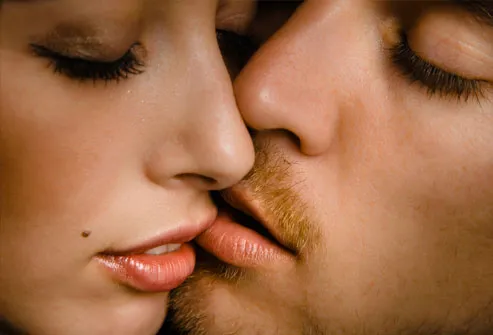 Couple with face and lips together, eyes closed