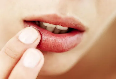Woman touching her lip, close-up