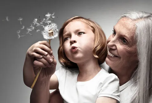 Grandmother and Grandchild Blowing Dandelion