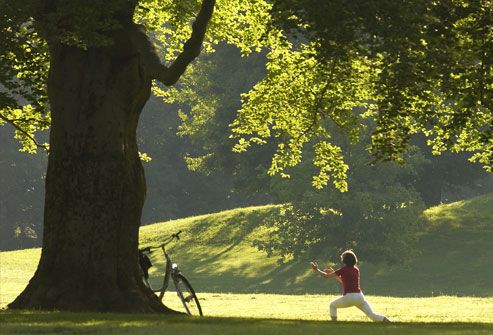 Woman doing yoga under tree