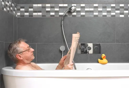 older man reading in bathtub