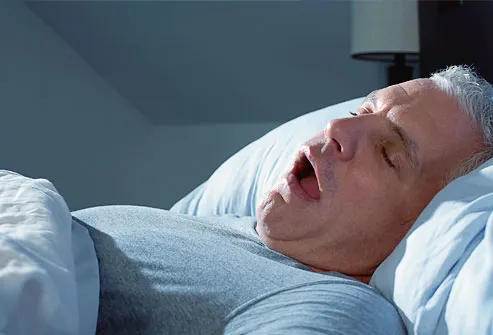 Man snoring in bed at night