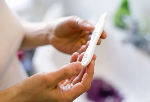 Woman holding home fertility test
