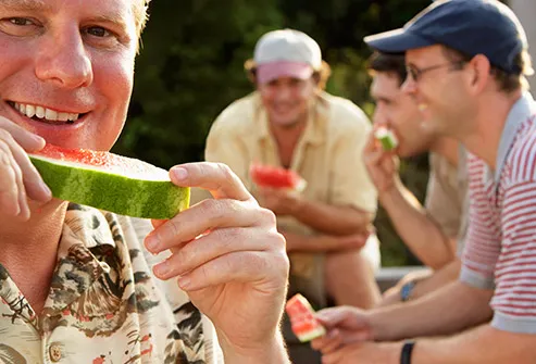 mature man eating watermelon