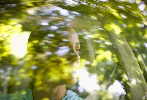 woman driving through forest
