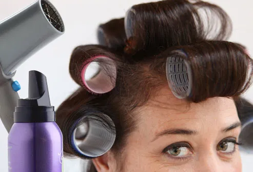 Hairdryer, mousse, and woman wearing curlers