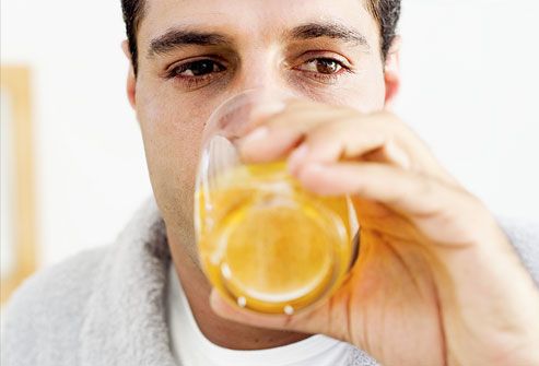 Man drinking juice wearing house robe