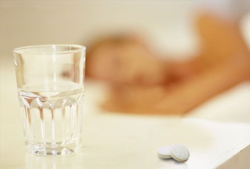 Asprin at bedside, sleeping woman in background