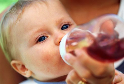 Baby drinking prune juice