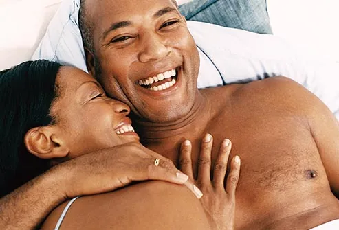 couple laughing in bed
