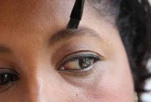 Woman Brushing Eyebrows