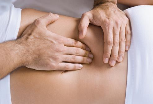 chiropractor adjusting womans spine