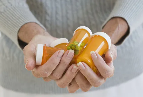 woman holding prescription bottles