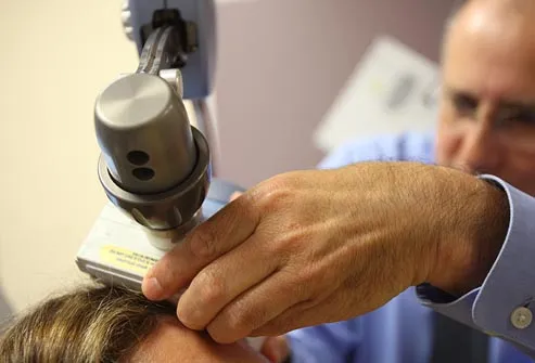 doctor applying transcranial magnetic stimulation
