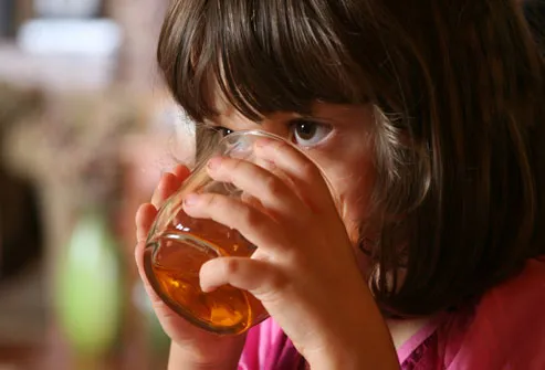 Little Girl Drinking From Glass