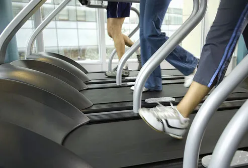 Man and women exercising on treadmill