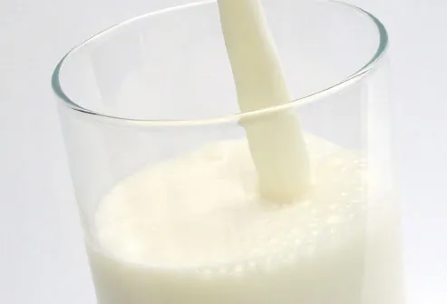 Stream of milk being poured into glass