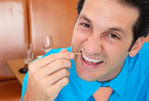 Man picking teeth with toothpick