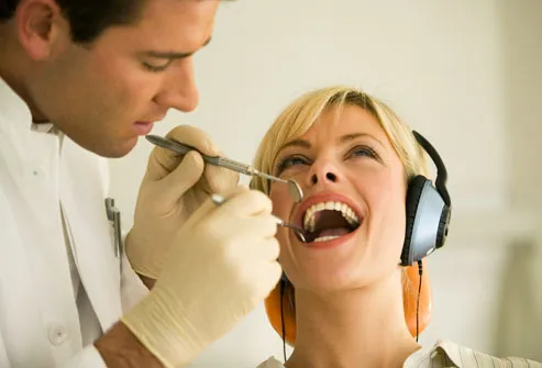 Woman wearing headphones at dentist