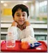 boy eating lunch in school cafeteria