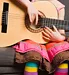 young girl holding guitar