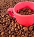 coffee cup among coffee beans