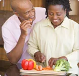Couple flirting while preparing healthy meal