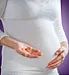 Pregnant woman holding vitamin supplements