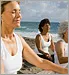 women meditating on beach