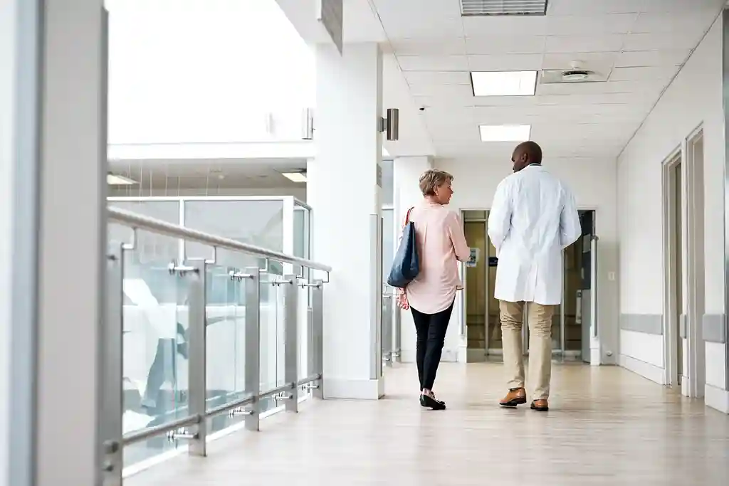 photo of doctor and patient in hospital corridor