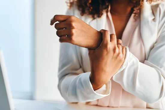 photo of businesswoman with wrist pain
