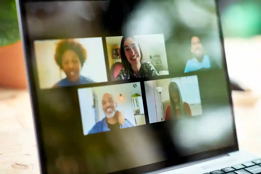 photo of faces on laptop screen during video chat