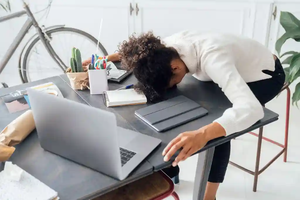 photo of woman sleeping on work desk