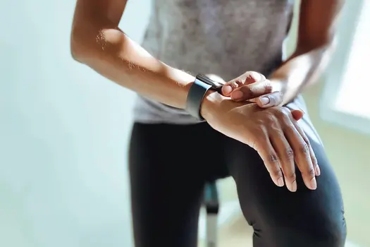 photo of woman checking fitness stats on watch