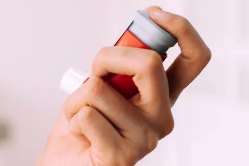 photo of woman holding asthma inhaler
