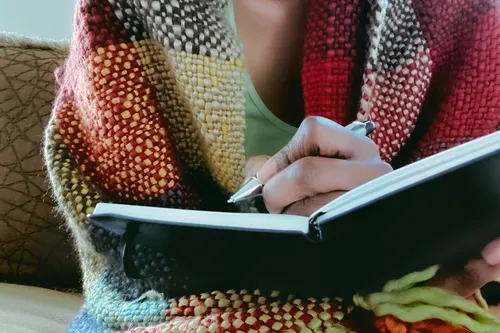 photo of woman writes in journal