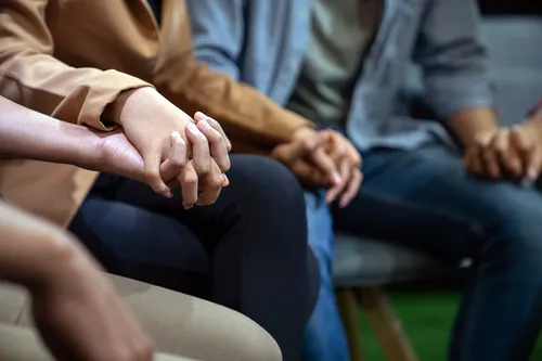 photo of holding hands in support group