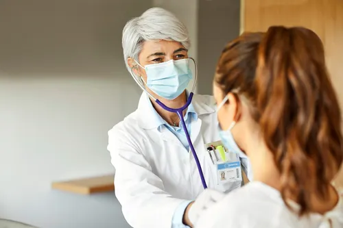Female doctor examining female patient