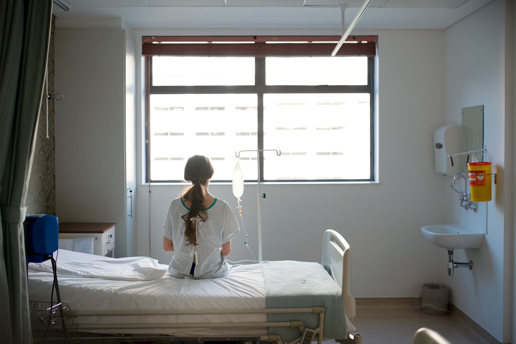 photo of patient sitting on hospital bed
